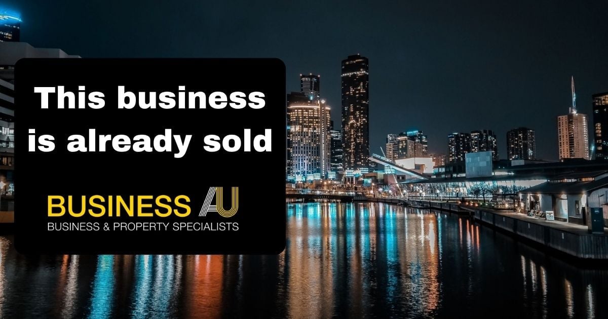 Night view of a city waterfront with a black overlay stating "This business is already sold" and the Business AU logo.